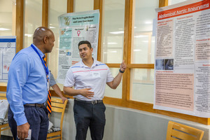 a student displaying his project at scholar day
